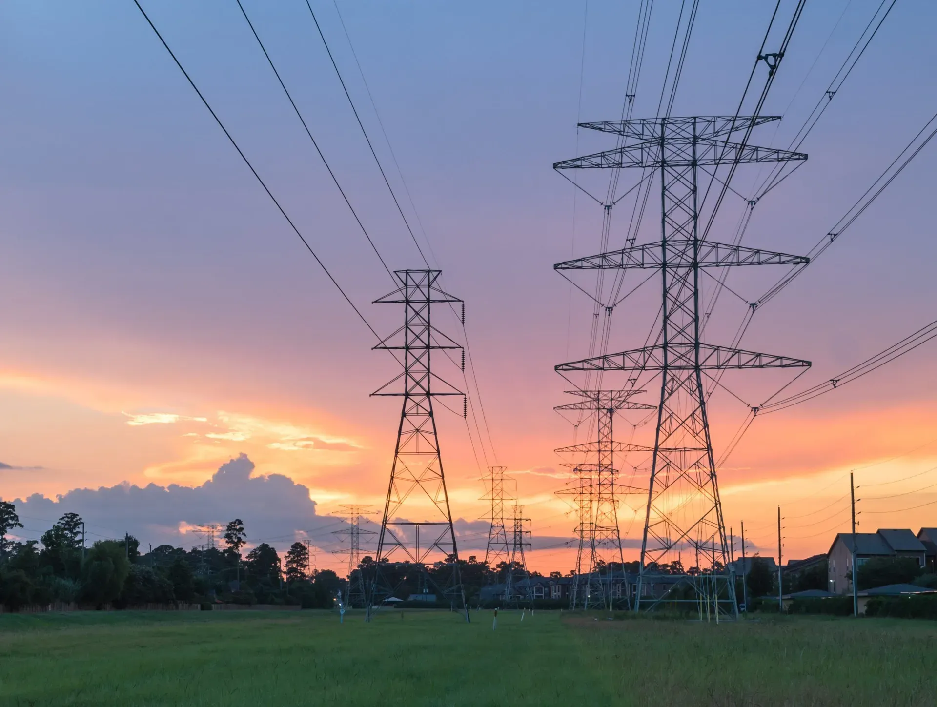 Group silhouette of transmission towers (power tower, electricity pylon, steel lattice tower) at twilight in US. Texture high voltage pillar, overhead power line, industrial background. Panorama style