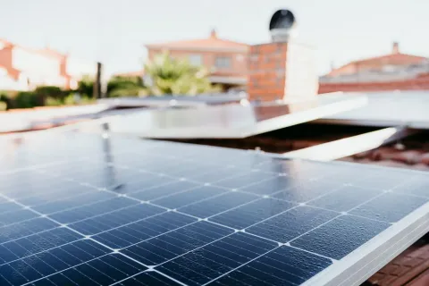 water drops on solar panel on roof during sunrise. Renewable energies and green energy concept