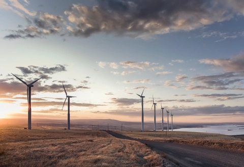 Large wind turbines against a sunset