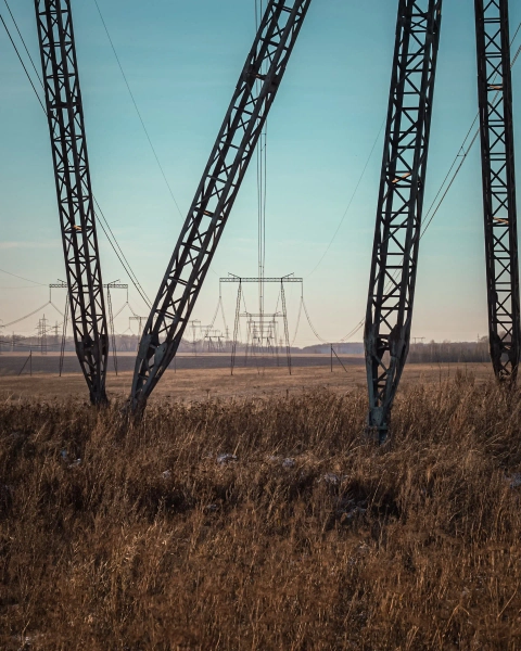 High voltage transmission pylons in field