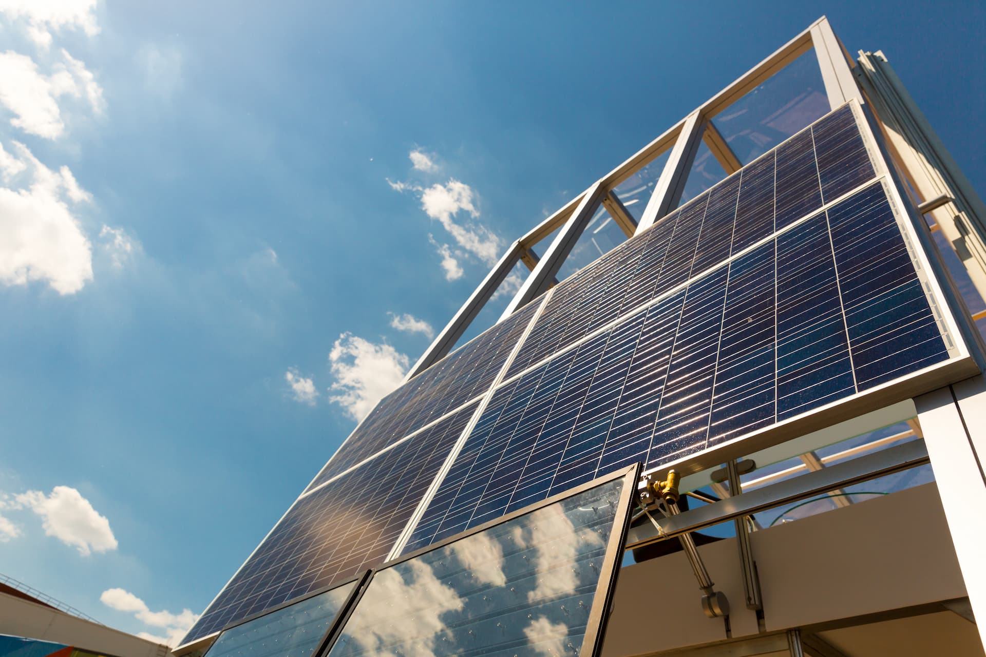 Building with solar panels against blue sky